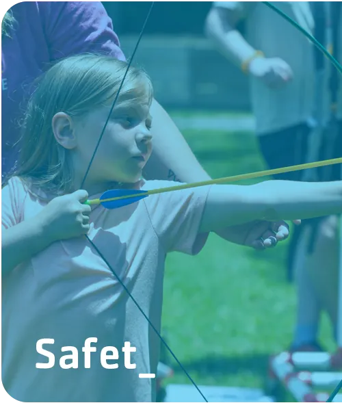 Safety — a child learning archery under supervision at the Y.