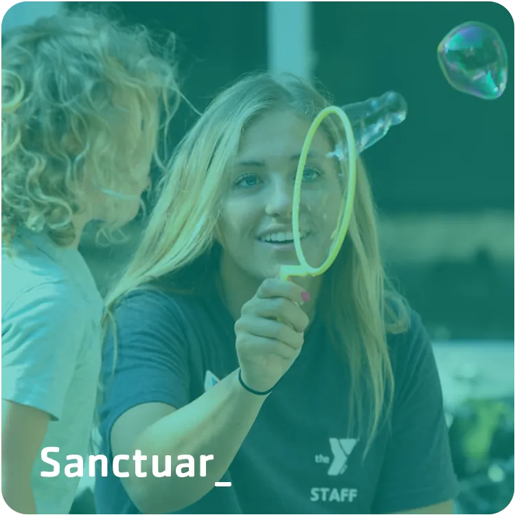 Sanctuary — a camper blowing bubbles outdoors at the Y.
