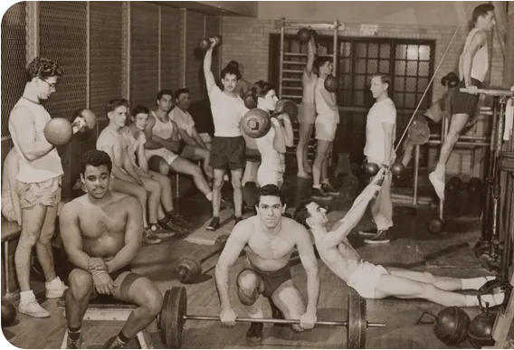 A historic photograph of a busy YMCA gymnasium.