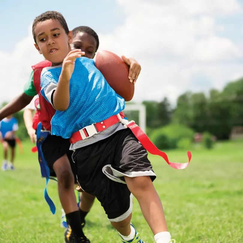 flag football playing running with the ball