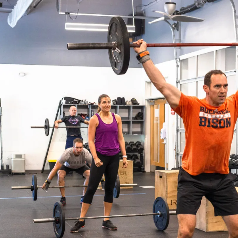 A man lifts a weight during a Westridge CrossFit session.