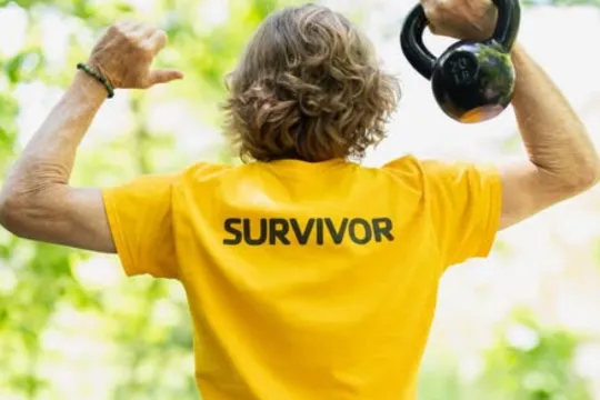 LIVESTRONG participant holds kettlebell.