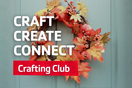 A fall wreath hangs on a door.
