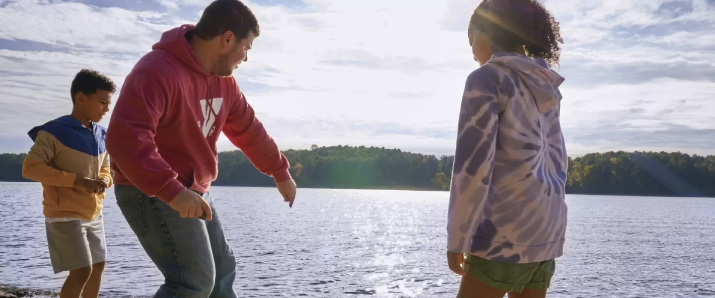 YMCA staff and kids skipping rocks