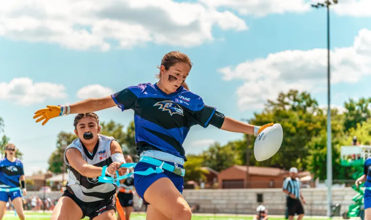 High school girls play a game of flag football.