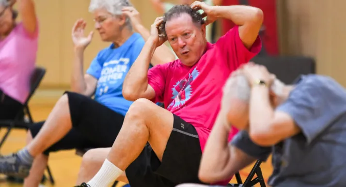 A group of people exercise during a group exercise class.