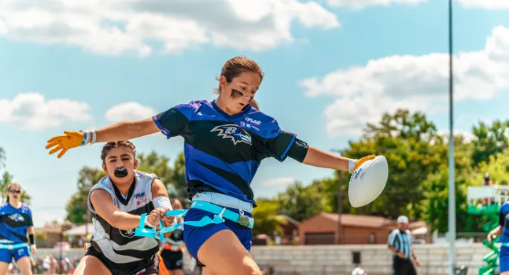 High school girls play a game of flag football.