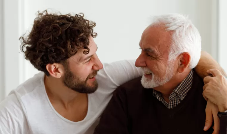 Adult son talks with elderly father