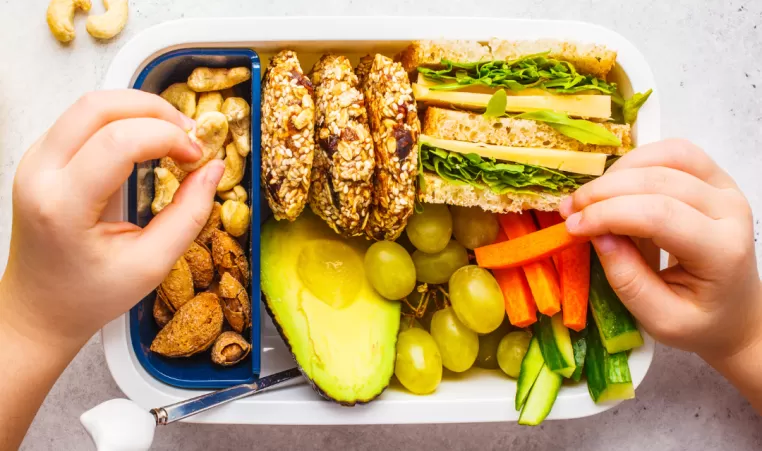 A healthy lunch for a kid made with fruits and vegetables.