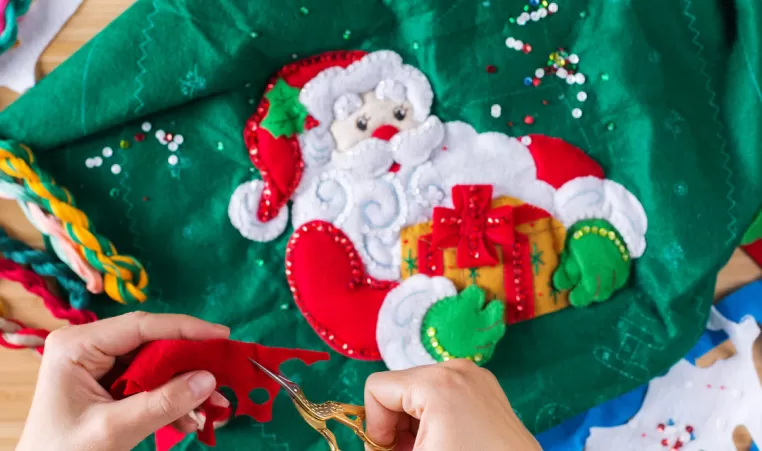 A pair of hands making holiday crafts.