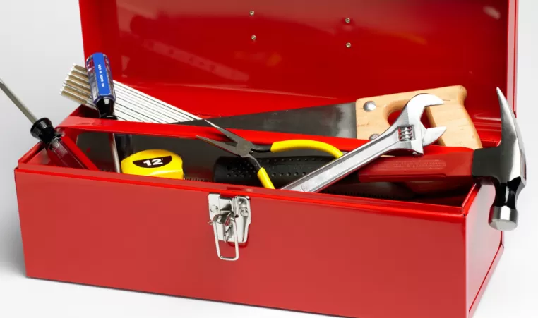 A red toolbox full of tools.