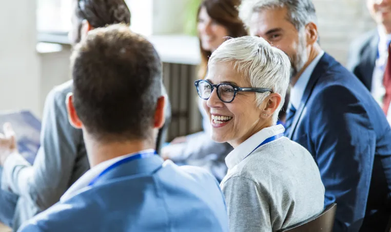 A group of seniors smile during a lecture.
