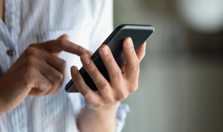 A closeup of a woman using her phone.