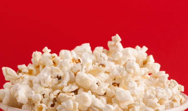 A closeup of popcorn in a bucket.
