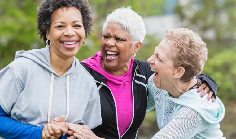 A group of older women laugh together.