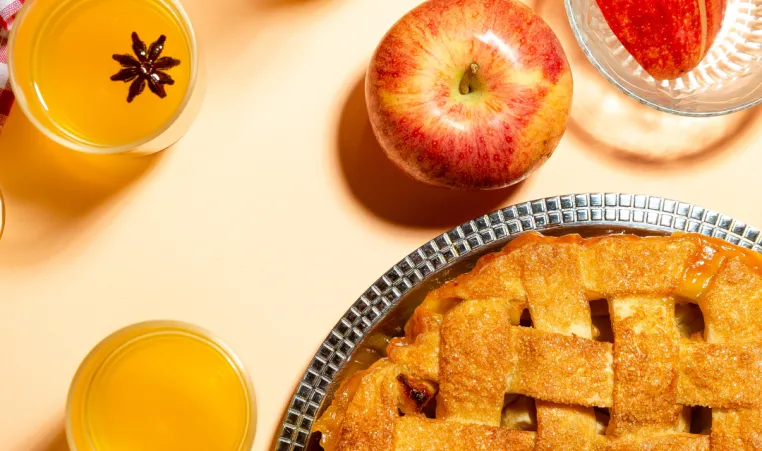 An above angle of a table full of different apple foods and drinks.