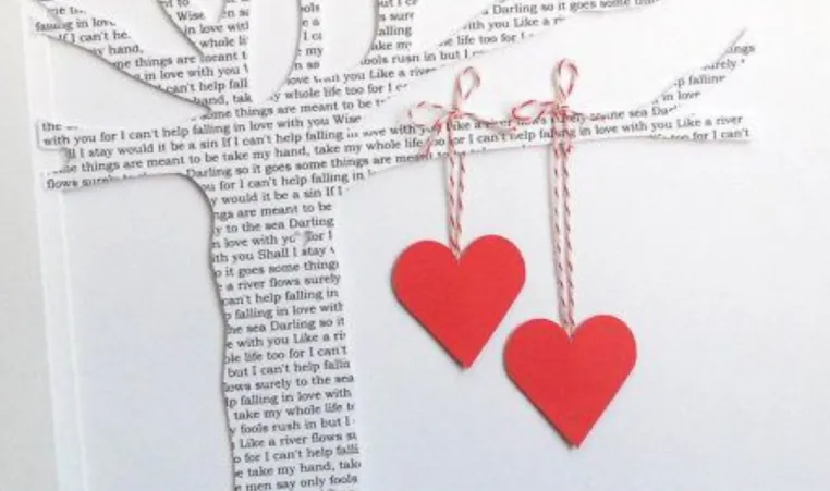 A craft of a paper tree with hearts.
