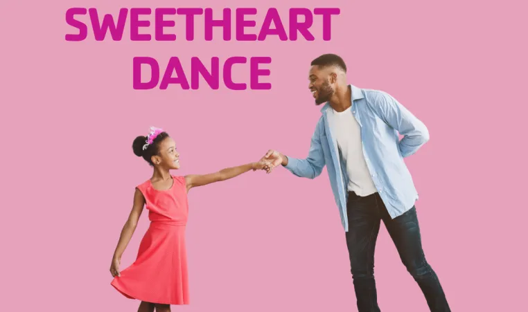 A father dances with his daughter for a family dance event.
