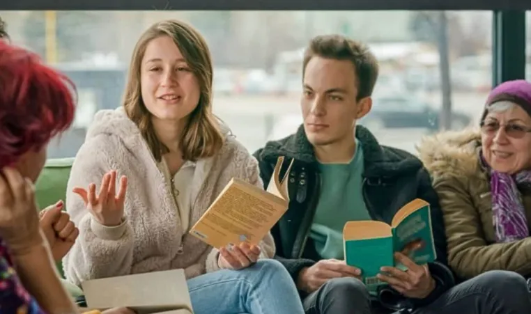 A diverse group of people enjoy a discussion during their book club.