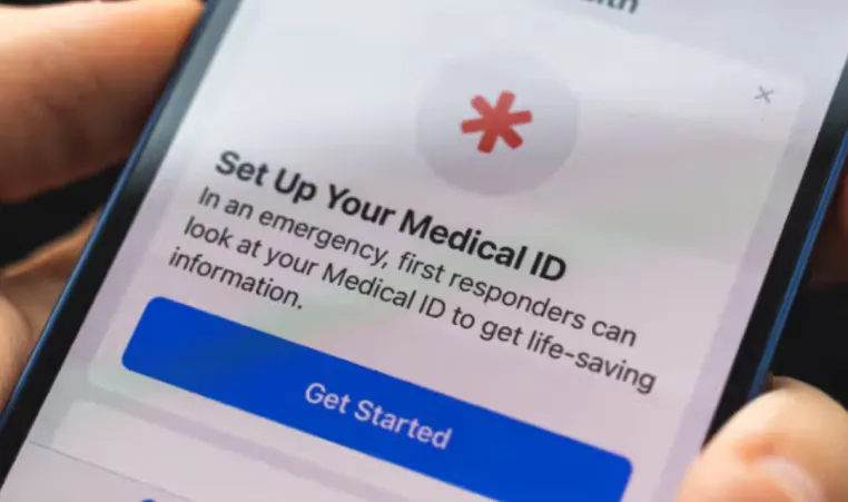 A closeup of someone holding a smartphone. The screen displays Medical ID information.