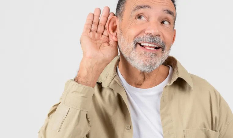Man listening holding hand to ear hearing