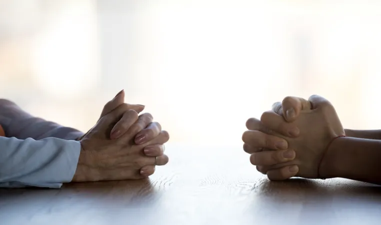 Two pairs of hands facing each other during conversation