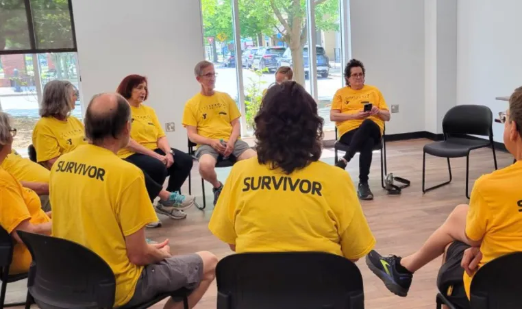 A group of people sit together during a LIVESTRONG at the YMCA support group meeting.