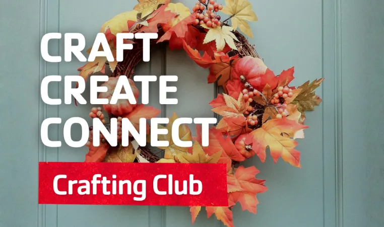 A fall wreath hangs on a door.