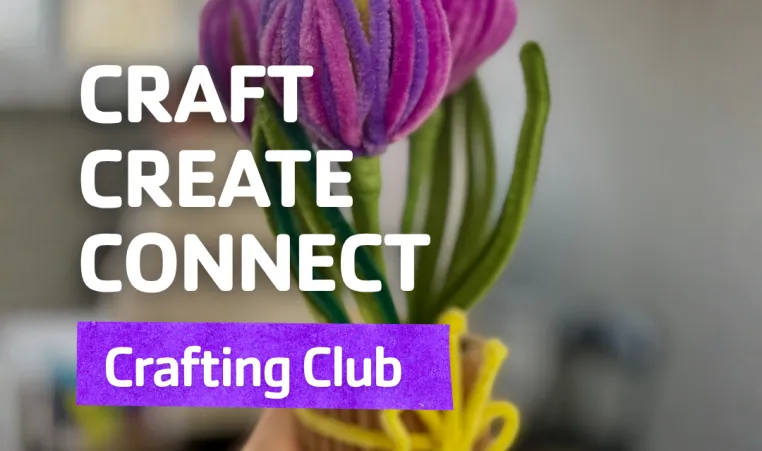 A picture of someone holding DIY craft flowers made from pipe cleaners.