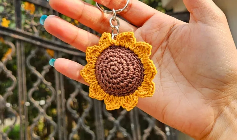 Hand holding a Sunflower Keychain Craft